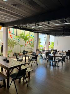 a dining room with tables and chairs and a mural at Pousada VilaZinha in Vila Velha