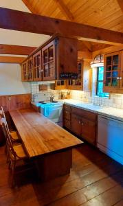 a large kitchen with a wooden table in a room at Coastal Cabin above the Clouds in Brookings