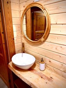 a bathroom with a white sink and a mirror at Chalet O Refúgio 1 in Penhas da Saúde