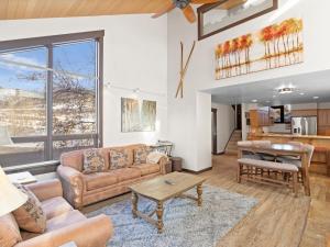 a living room with a couch and a table at Red Pine Condominiums by All Seasons Resort Lodging in Park City