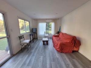 a living room with a bed and a couch at Quinta con pileta y quincho in Fátima