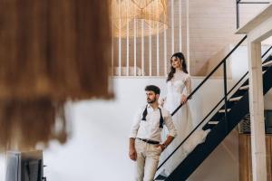 a bride and groom walking down the stairs at Villa Lis in Ivano-Frankivsk