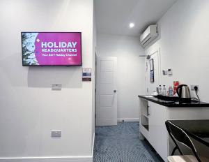 a kitchen with a tv hanging on the wall at Park Inn Palace in Dover