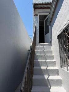 a set of stairs leading up to a door at Hospedaje Sarmiento in Carlos Casares