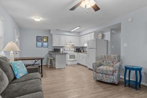 a living room with a couch and a kitchen at Boardwalk Shores D in Atlantic Beach