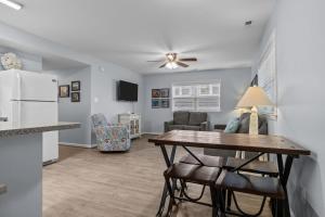 a kitchen and living room with a table and a refrigerator at Boardwalk Shores D in Atlantic Beach