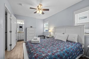a bedroom with a bed and a ceiling fan at Boardwalk Shores D in Atlantic Beach +27 photos