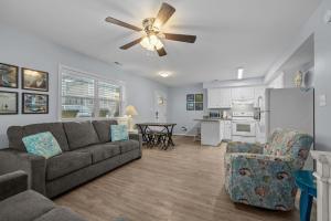 a living room with a couch and a ceiling fan at Boardwalk Shores D in Atlantic Beach