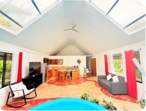 a living room with a couch and a table at Mystic Solarium Private Indoor Pool in Chachagua