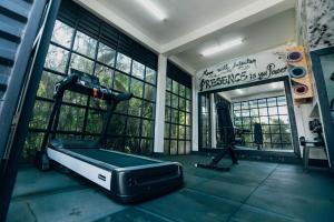 a room with a gym with a treadmill and windows at Makeri Residence - Musanze , Rwanda in Ruhengeri