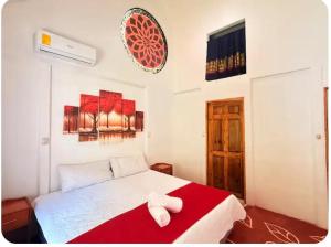 a bedroom with a bed with a red blanket at Mystic Solarium Private Indoor Pool in Chachagua