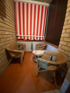 a room with a large window with a red and white striped curtain at Appartamento MiMoSa Scalea in Scalea +54 photos