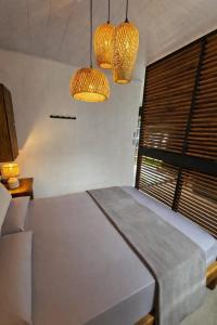 a bedroom with a bed with two lights and a window at Casita Don Marco in Bocas Town +11 photos