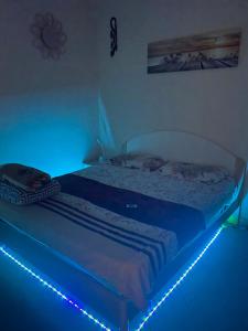 a bed in a room with a blue light at Appartamento MiMoSa Scalea in Scalea