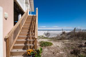 a stairway leading up to a house with the beach at High Tide Paradise in St. Augustine