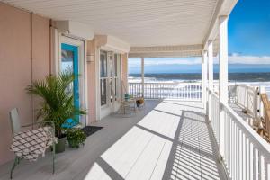 a porch with a view of the ocean at High Tide Paradise in St. Augustine