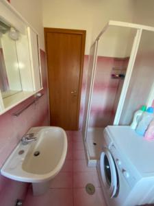 a bathroom with a sink and a toilet and a shower at Appartamento MiMoSa Scalea in Scalea