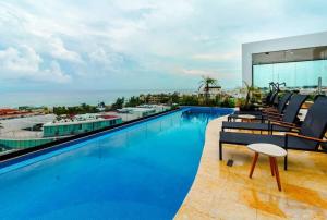a swimming pool on top of a building at Central Studio - Rooftop Pool Gym Near Beach in Playa del Carmen