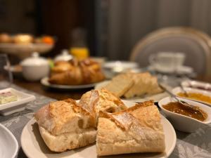 a plate of bread on a table with other foods at Maison Galimard in Flavigny-sur-Ozerain