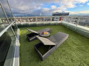 a balcony with a table and chairs on top of a building at Grand Penthouse And SPA in Riga