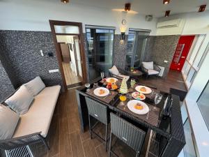 an aerial view of a living room with a table and chairs at Grand Penthouse And SPA in Riga
