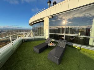 a balcony with two chairs and a table on a building at Grand Penthouse And SPA in Riga