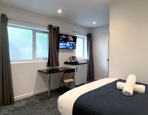a bedroom with a bed and a desk and a window at Park Inn Palace in Dover