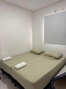 a large bed in a white room with two pillows at CASA MARECHAL FRANCÊs in Marechal Deodoro +7 photos