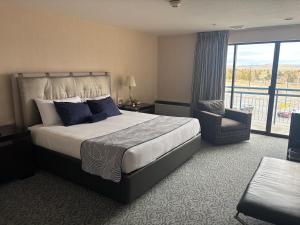 a hotel room with a bed and a balcony at Barton's Club 93 in Jackpot