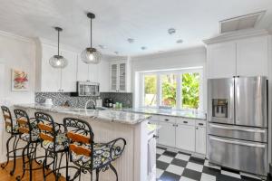a kitchen with a black and white checkered floor at Mulberry Oasis in St. Augustine