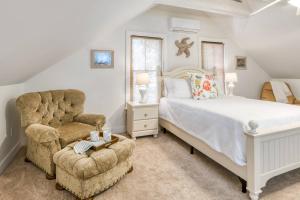 a bedroom with a bed and a chair at Mulberry Oasis in St. Augustine