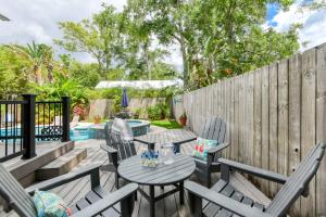 a patio with a table and chairs and a fence at Mulberry Oasis in St. Augustine