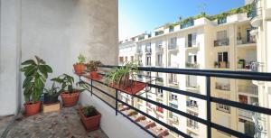 a balcony with potted plants and buildings at Suite Imperazur Five stars Holiday House in Nice