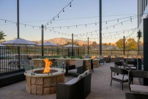 a patio with a fire pit and tables and chairs at Residence Inn by Marriott St. George in Washington