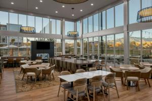 a restaurant with tables and chairs and windows at Residence Inn by Marriott St. George in Washington