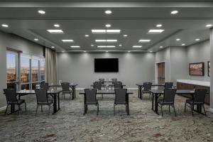 a conference room with tables and chairs and a flat screen tv at Residence Inn by Marriott St. George in Washington +35 photos