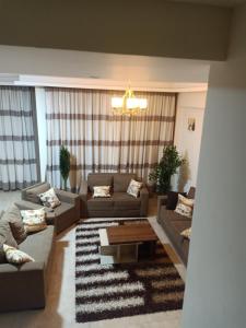 a living room with couches and a coffee table at Sky Star Villa 97 in Hurghada
