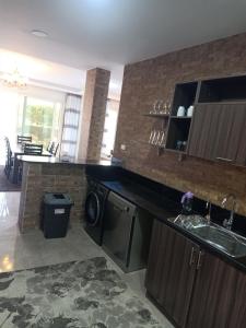 a kitchen with a sink and a dishwasher at Sky Star Villa 97 in Hurghada