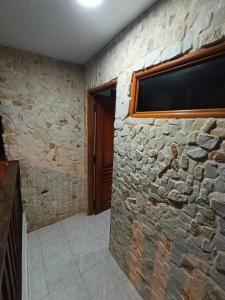a stone wall in a room with a window at Glamar Apartamento in Arboletes