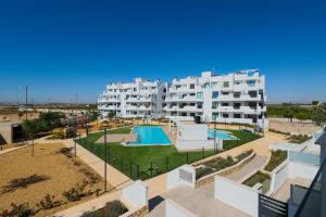 a large white apartment building with a swimming pool at Santa Rosalìa - Casa Elsalie in Torre-Pacheco