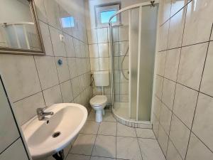 a bathroom with a sink and a toilet and a shower at New! Apartment Complex "S" in Čelina +34 photos