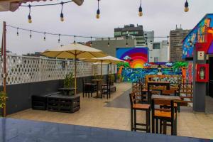 an outdoor patio with tables and chairs and umbrellas at Miraflores Thay Colonial in Lima
