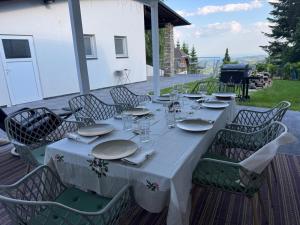a table with plates and napkins on a patio at Chalet Weiß in Mönichkirchen