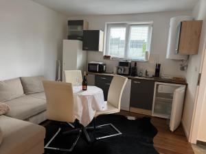 a small living room with a table and a kitchen at Chalet Weiß in Mönichkirchen +18 photos