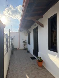 a balcony of a house with a door and plants at Casa Amore Design - South Sardinia - in San Gavino Monreale