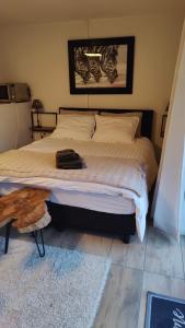 a bedroom with a large bed with a wooden table at Studio Zebra in Heikant