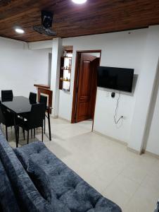 a living room with a couch and a table at Glamar Apartamento in Arboletes +17 photos