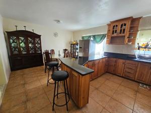 a kitchen with wooden cabinets and a counter top at Quiet Escape Unity Hall in Montego Bay