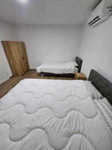 a bedroom with a large bed in a room at Montana apartman in Han Pijesak