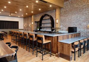 a bar in a restaurant with a row of stools at Lightwell Hotel & Spa in Hood River